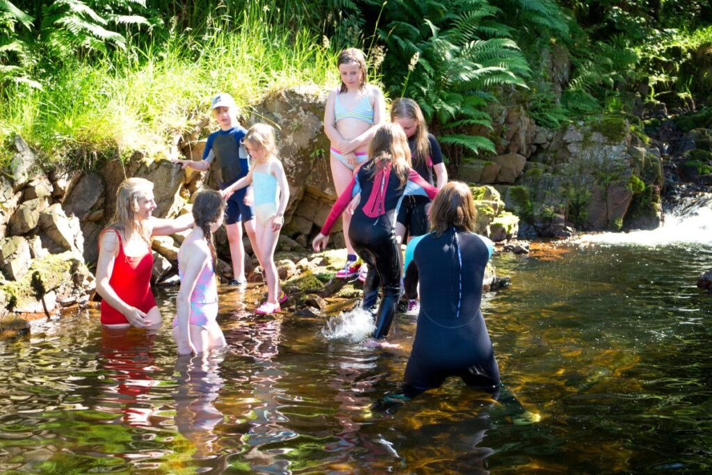 Amigos chapoteando en un río.